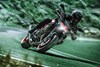 Front angle of a person riding a motorcycle on a road.