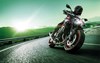 Front angle of a person riding a motorcycle on a road.