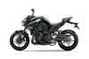 Profile angle of a black motorcycle staged in a white studio background.