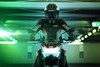 Front angle of a person on a motorcycle in a garage.