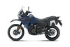 Side angle of a blue motorcycle staged in a white studio background.