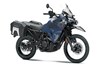 Three-quarter front angle of a blue motorcycle staged in a white studio background.