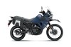 Profile angle of a blue motorcycle staged in a white studio background.