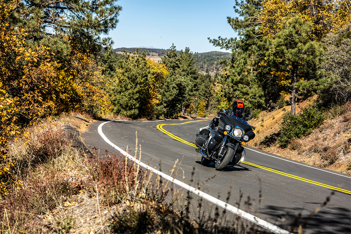 Front angle of a person riding a motorcycle on a road.
