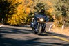 Front angle of a person riding a motorcycle on a road.