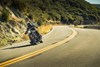 Front angle of a person riding a motorcycle on a road.