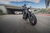 Front angle of a person riding a motorcycle on a road.