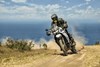 Front angle of a person riding a motorcycle on an off-road trail.