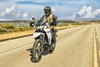 Front angle of a person riding a motorcycle on a road.