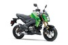 Three-quarter front angle of a green motorcycle staged in a white studio background.