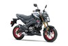 Three-quarter front angle of a gray motorcycle staged in a white studio background.