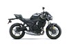 Profile angle of a black motorcycle staged in a white studio background.