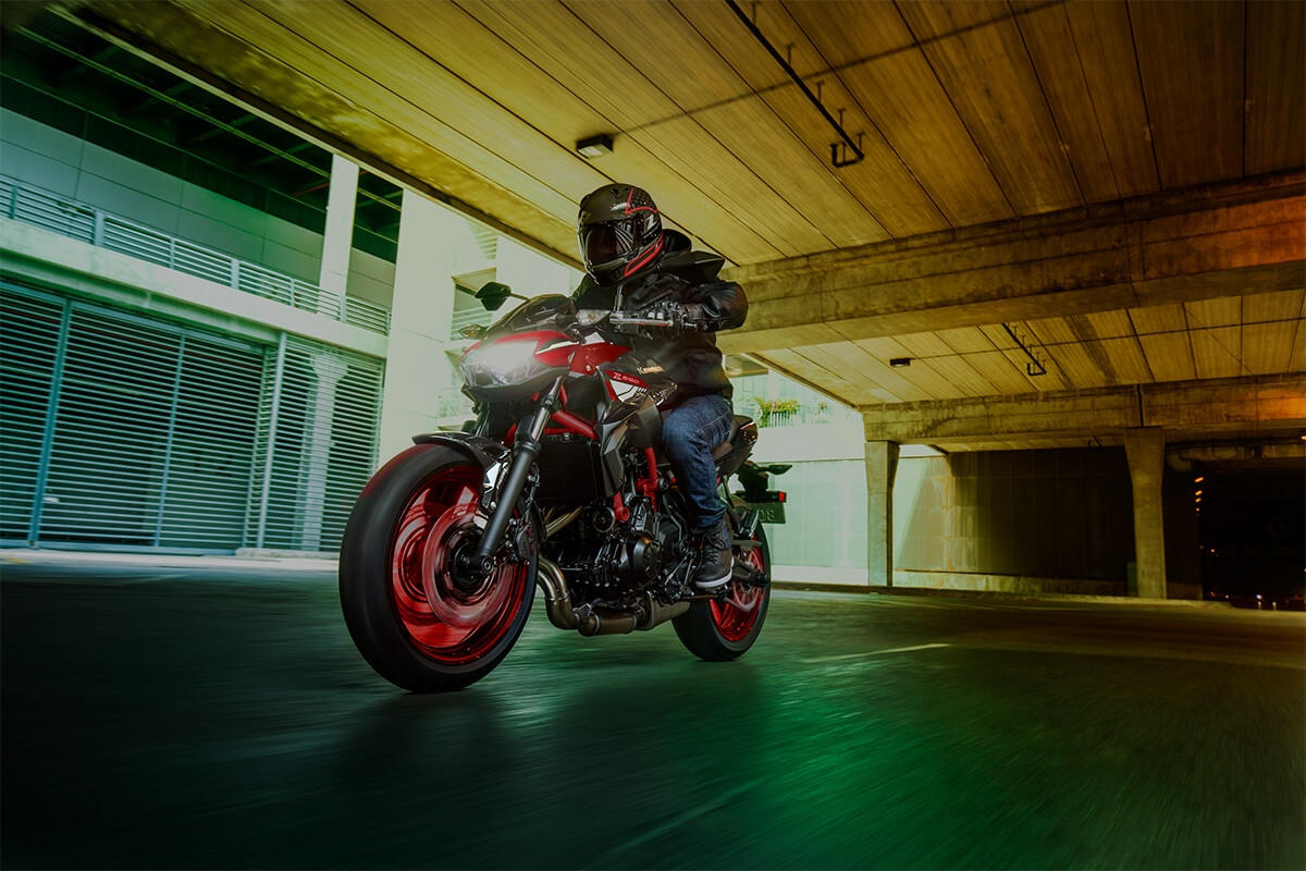 Three-quarter front angle of a person riding a motorcycle in a garage.