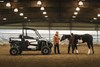 Side angle of a side x side parked in a barn.