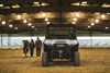 Front angle of a side x side parked in a large barn.