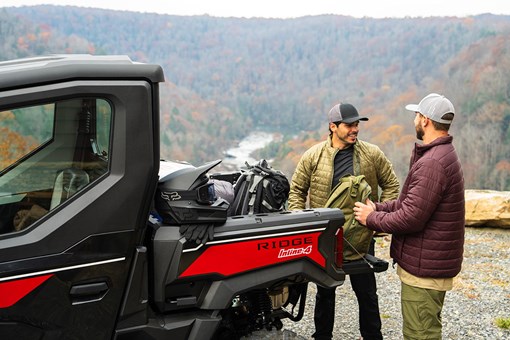 Rear angle of a person loading the back of a side x side. opens in a new window
