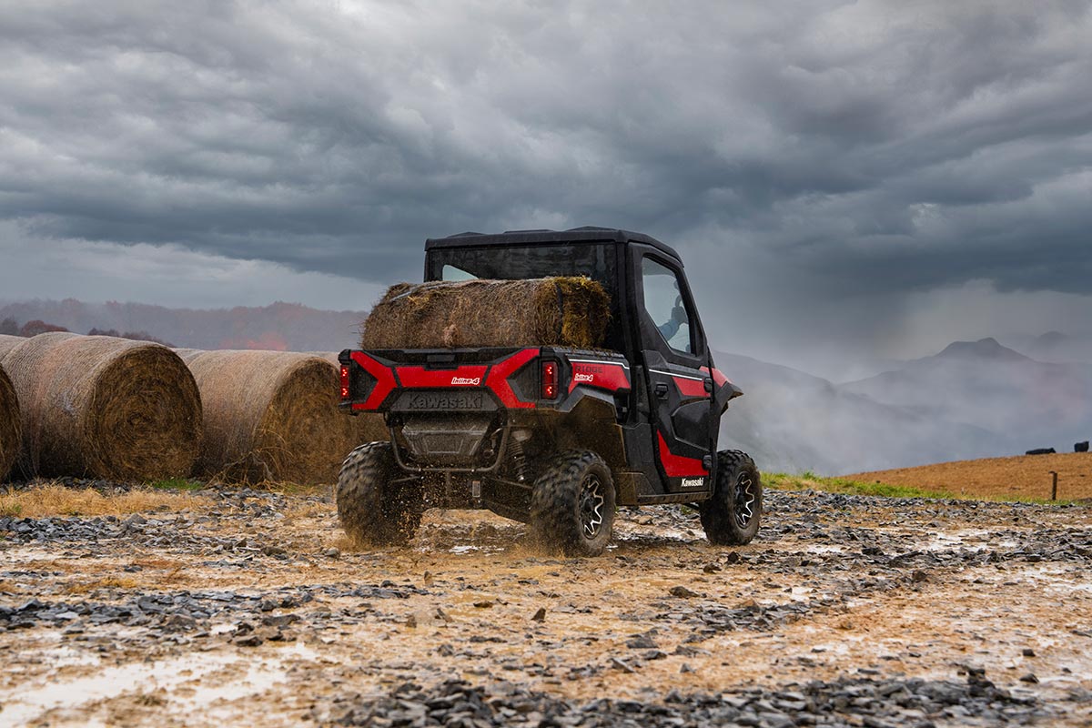  Rear angle of a person driving a side x side off-road.