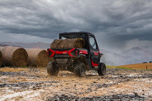  Rear angle of a person driving a side x side off-road. opens in a new window