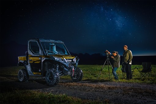 Three-quarter front angle of a side x side parked under stars. opens in a new window
