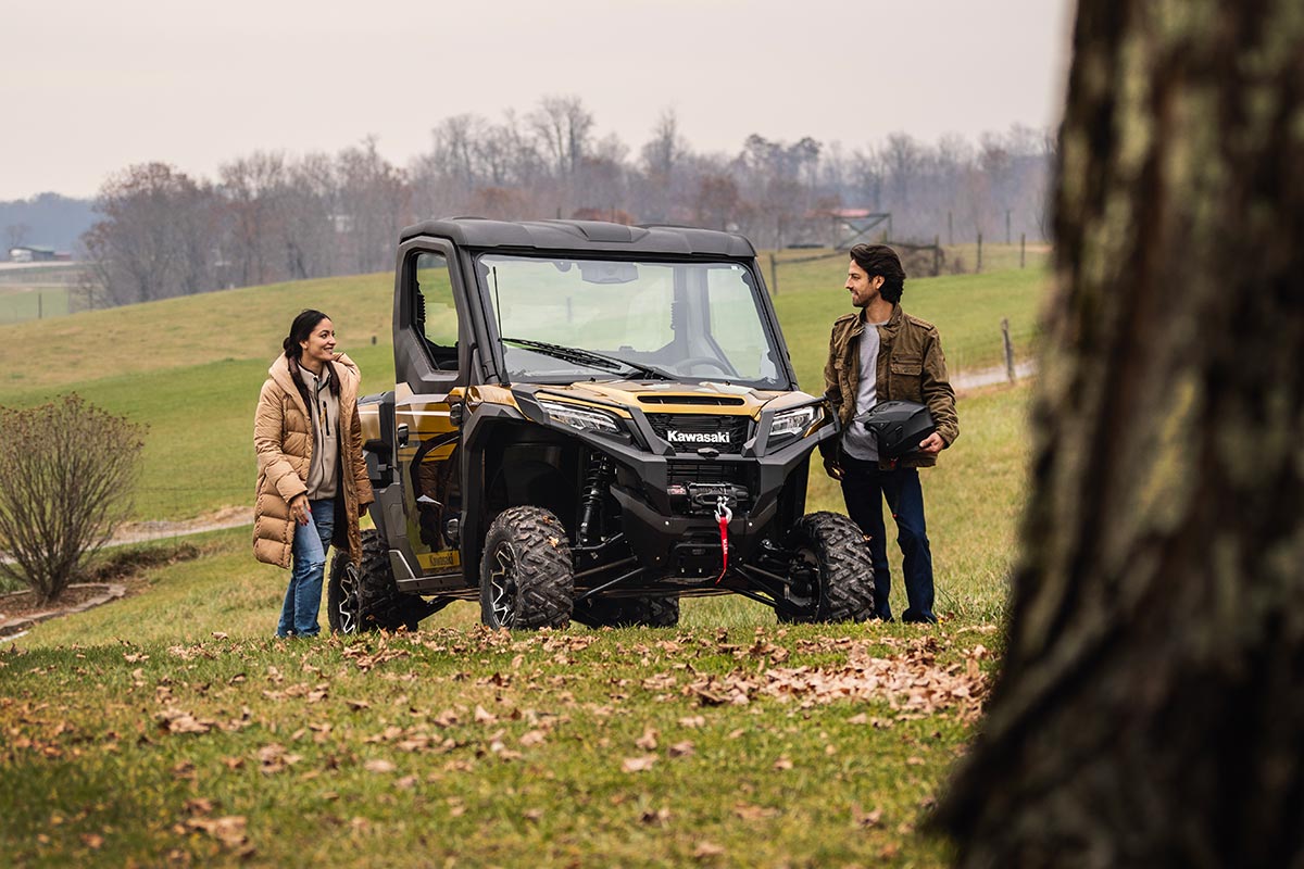 Front angle of a side x side parked in the distance.