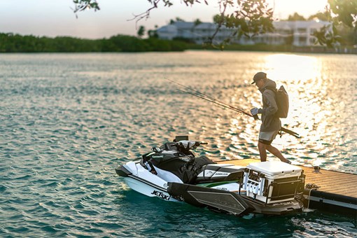 Three-quarter rear angle of a personal watercraft near a dock. opens in a new window