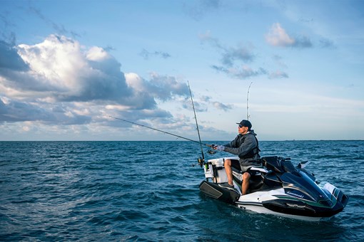 Three-quarter front angle of a person fishing on a personal watercraft in the ocean. opens in a new window