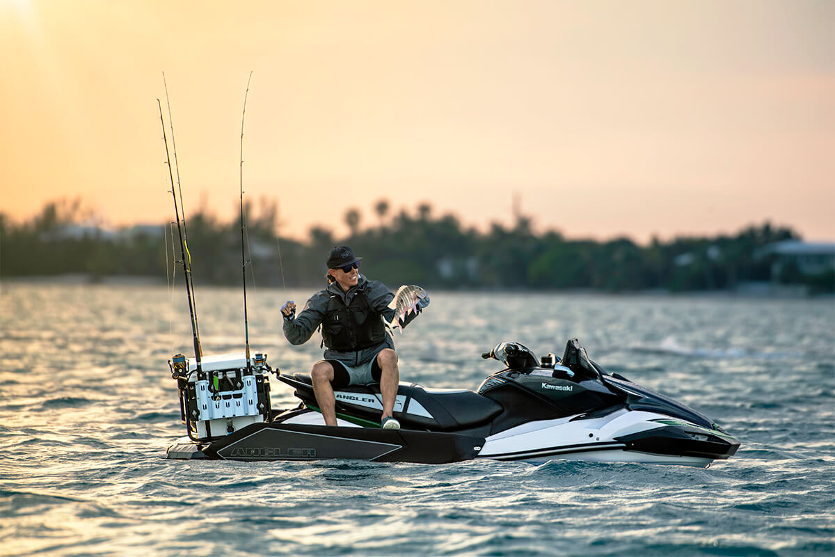 Profile angle of a person seated on a personal watercraft in water.