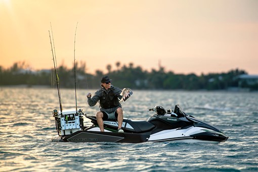 Profile angle of a person seated on a personal watercraft in water. opens in a new window