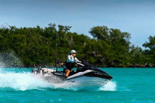 Profile angle of a person riding a personal watercraft in water. opens in a new window