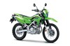 Three-quarter front angle of a green motorcycle staged in a white studio background.