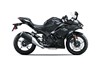 Side angle of a black motorcycle staged in a white studio background.