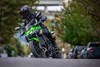 Front angle of a person riding a motorcycle on a street.