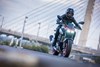 Front angle of a person riding a motorcycle on a road.