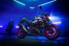 Side angle of a motorcycle staged in a garage.