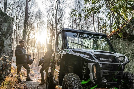 Front angle of a side x side parked near trees. opens in a new window