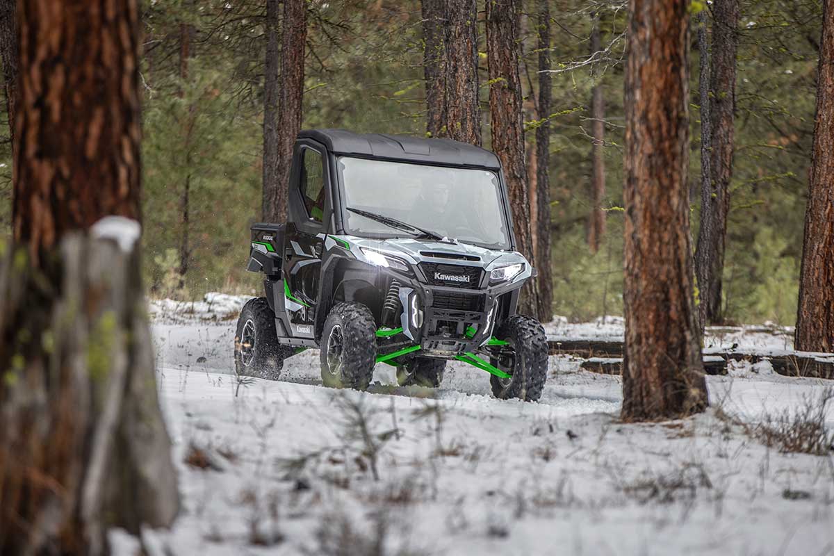 Front angle of a person driving a side x side in the snow.