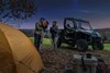 Three-quarter front angle of a side x side parked under stars.
