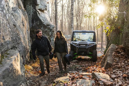 Front angle of a side x side parked near large rocks. opens in a new window