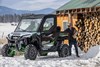 Three-quarter front angle of a side x side parked in the snow.