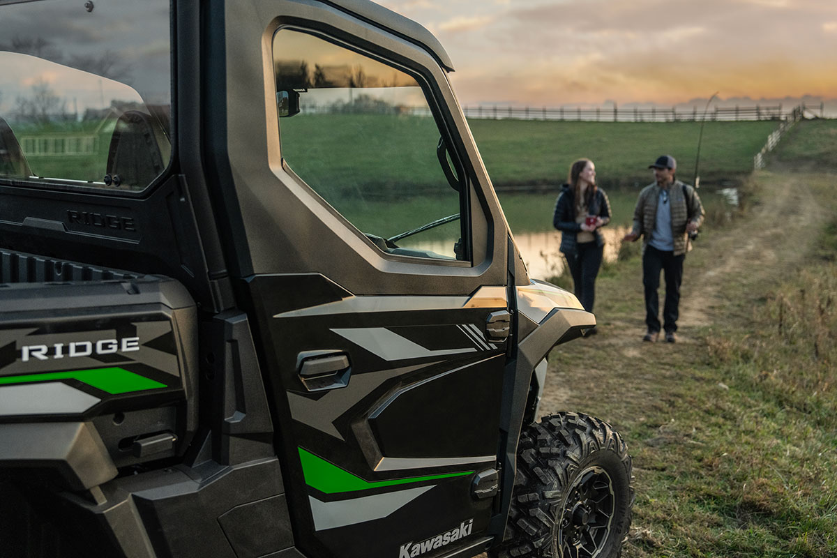 Side angle of a side x side parked with people walking up in the distance.