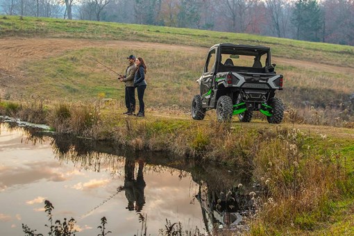 Rear angle of a side x side parked next to a pond. opens in a new window