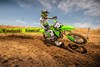 Three-quarter front angle of a person making a sharp turn on a motorcycle off-road.