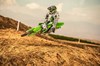 Three-quarter front angle of a person making a jump on a motorcycle off-road.