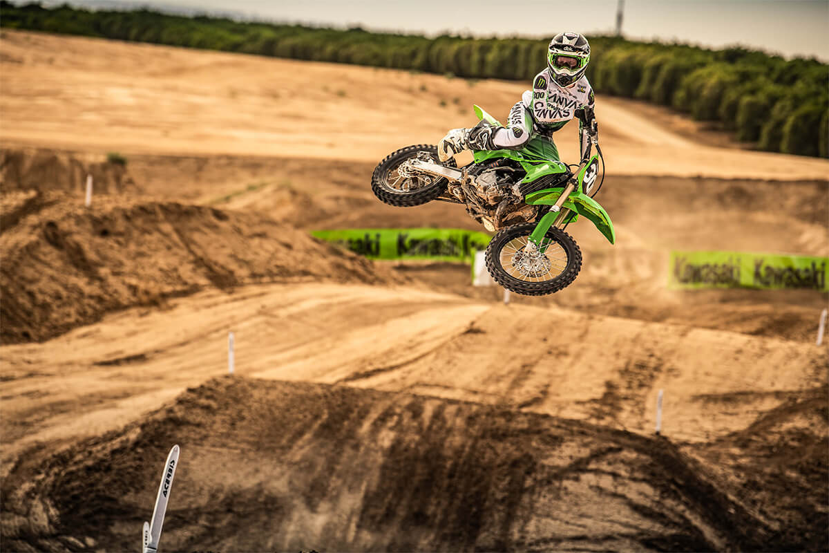 Front angle of a person mid air on a motorcycle off-road.
