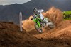 Three-quarter front angle of a person making a turn on a motorcycle off-road.