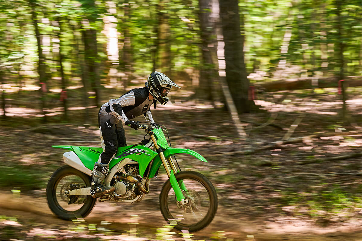 Side angle of a person riding a motorcycle off-road.