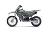Side angle of a gray motorcycle staged in a white studio background.