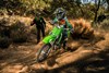 Three-quarter front angle of a person riding a motorcycle off-road.