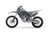 Side angle of a gray motorcycle staged in a white studio background.