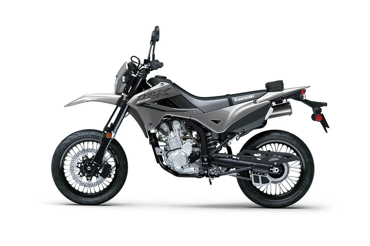 Side angle of a gray motorcycle staged in a white studio background.
